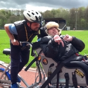 A participant and member of staff using an adaptive cycle