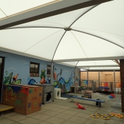 A picture of the outdoor classroom, showing the large canopy roof and the play equipment